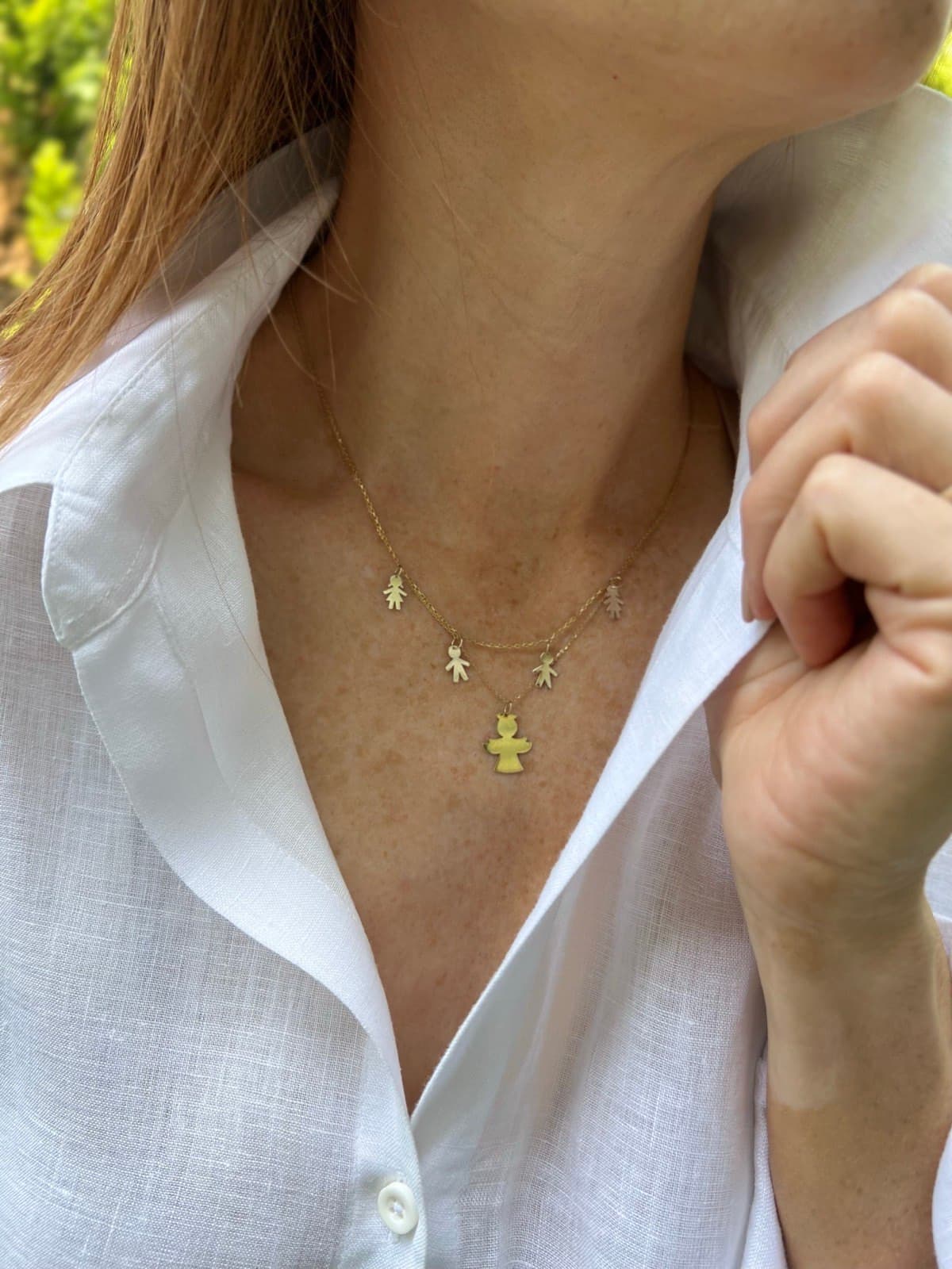 Cadena de oro con dijes y ángel