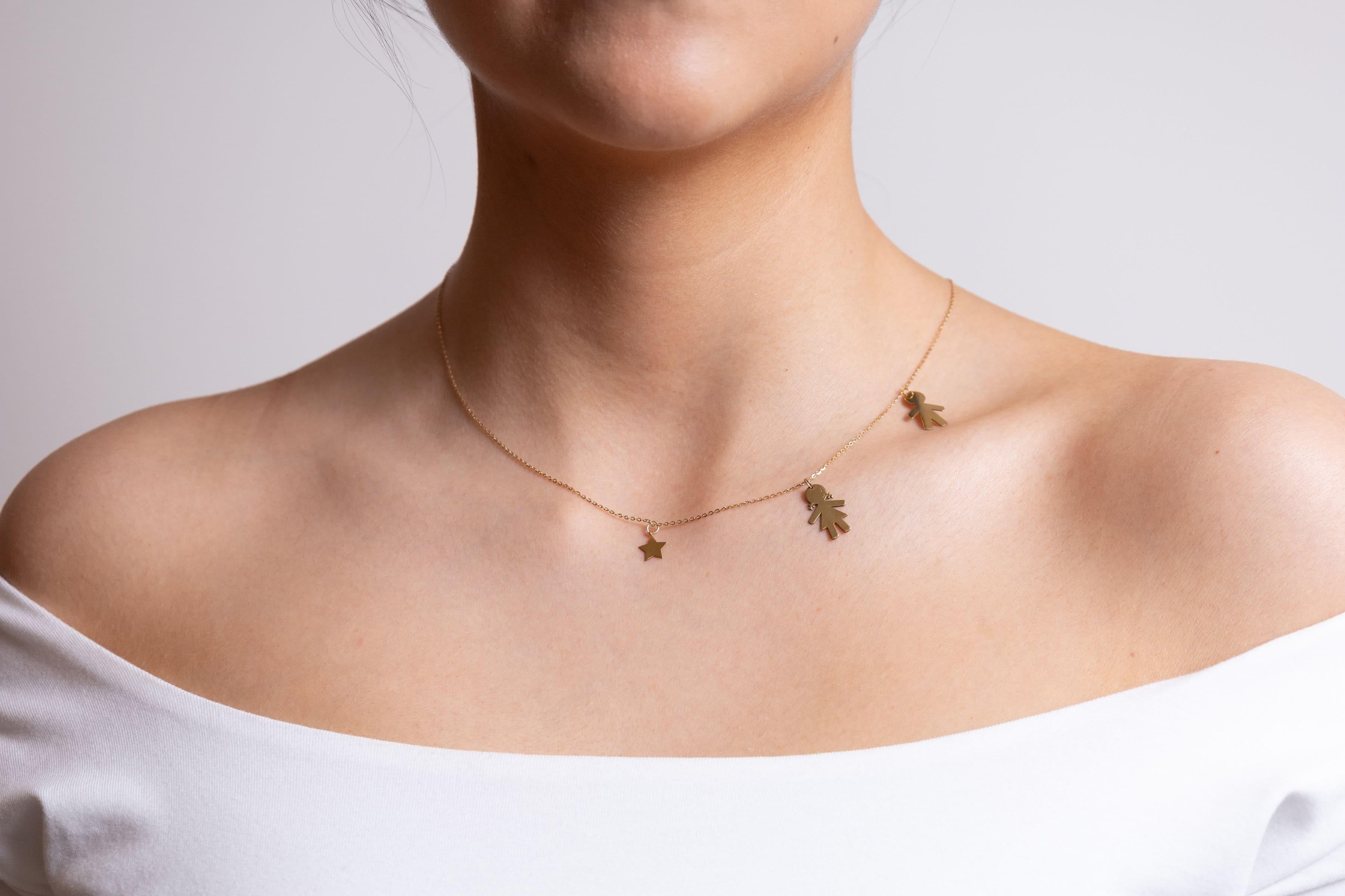 Cadena oro: niño, estrella, niña